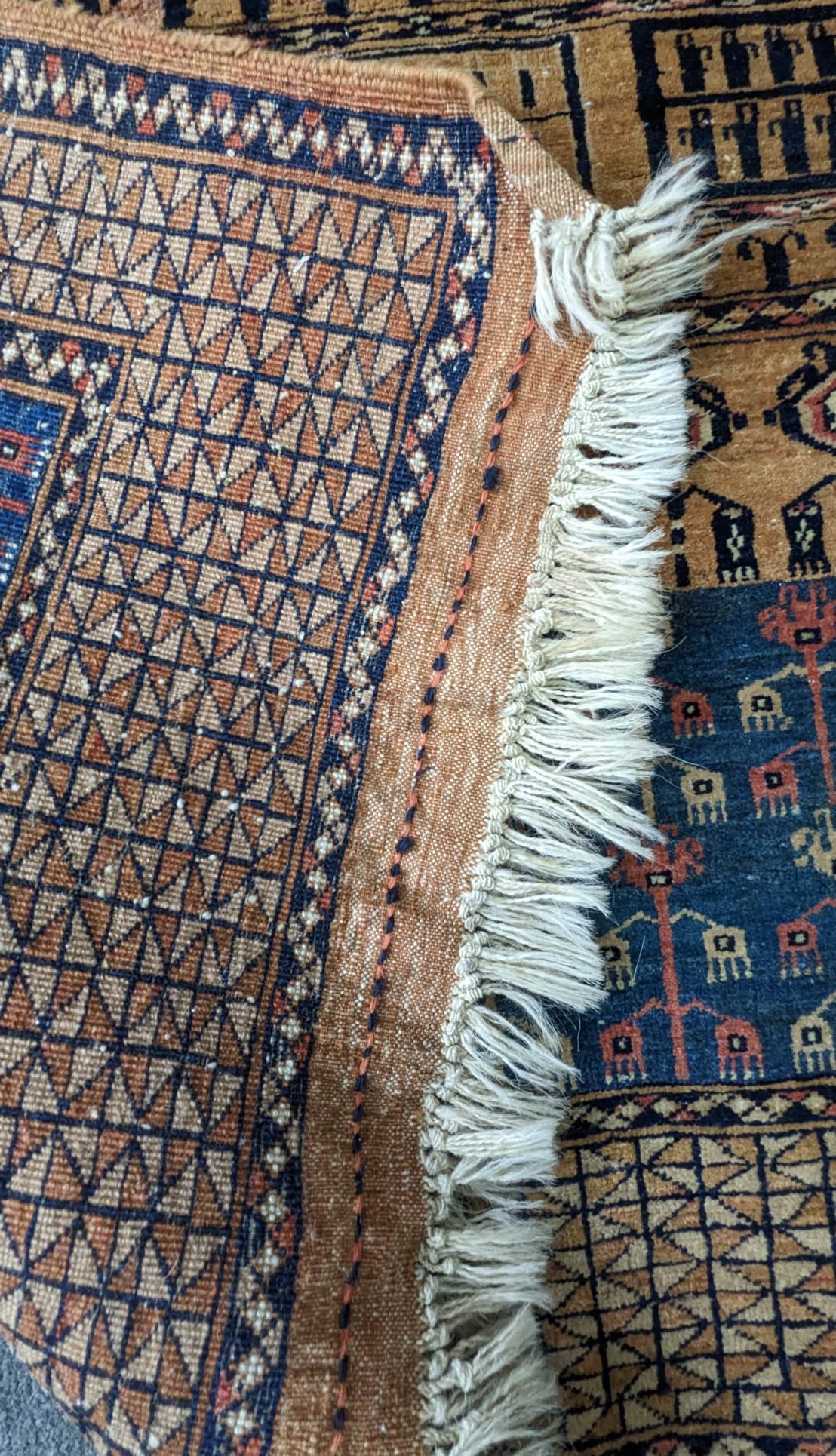 A Caucasian beige ground rug with central field of stylised motifs, 204 x 130cm